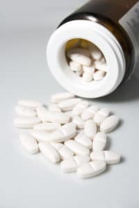 Prescription drug prices Spilled pills from a bottle