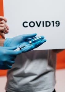 COVID vaccine person-holding-syringe