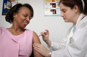 Can Employers Require Flu Shots? Woman getting vaccine from doctor